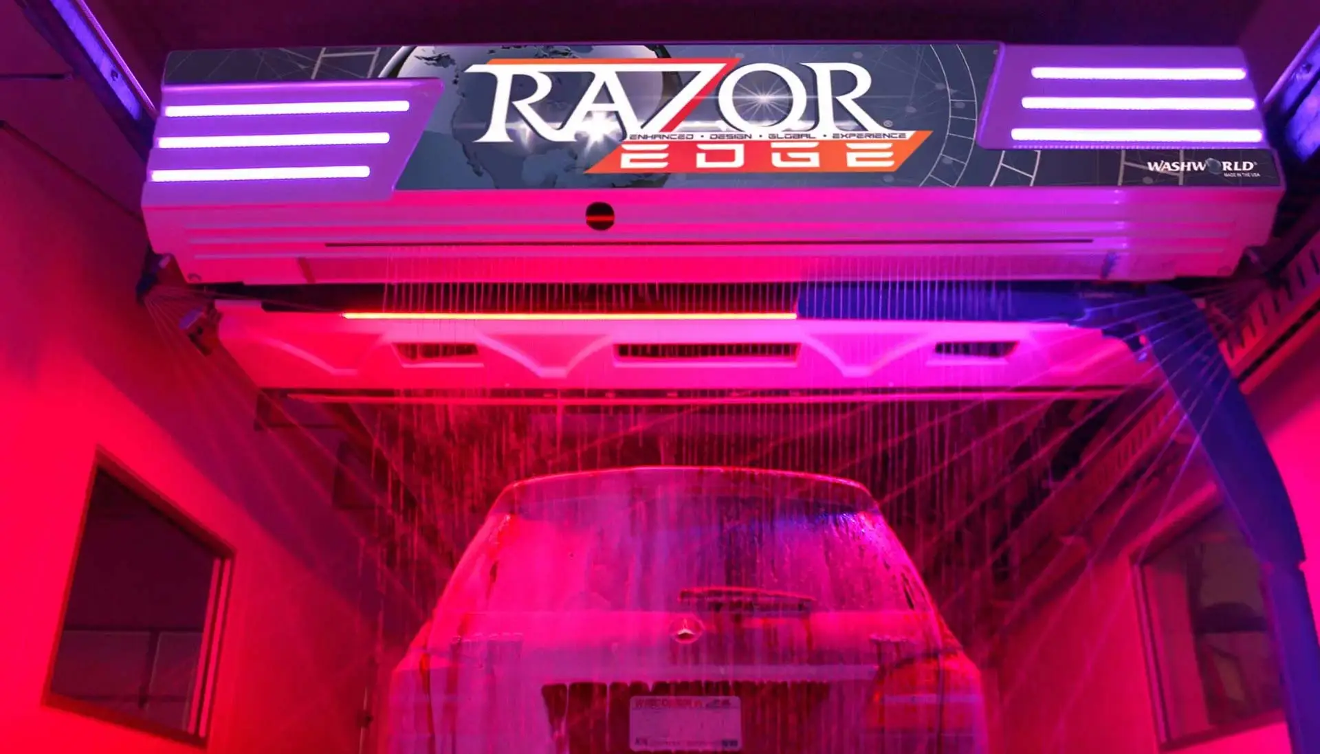 A car gliding through a touchless car wash, bathed in vibrant red LED lights, with suds cascading over the vehicle, showcasing the advanced Razor Edge wash process.